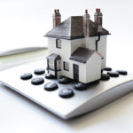 House on calculator concept for mortgage calculator, home finance or saving for a house loan